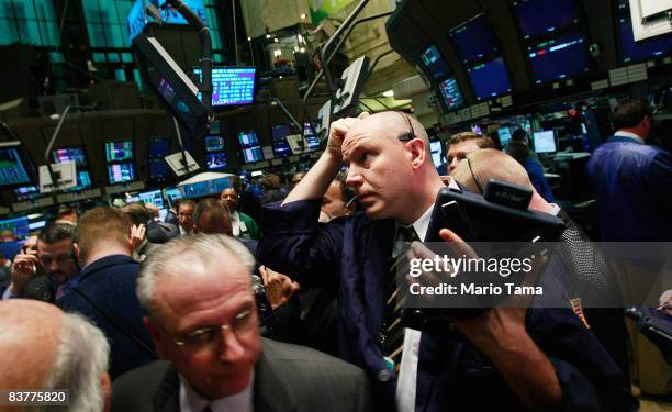 Traders work on the floor moments before the morning bell at the New York Stock Exchange November 21, 2008 in New York City. Stocks were up in...