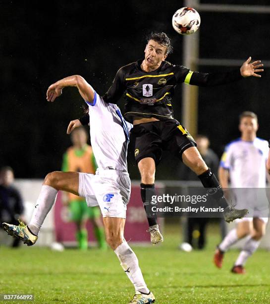 Alex Janovsky of Moreton Bay gets above Jacob Boutoubia of Gold Coast City during the FFA Cup round of 16 match between Moreton Bay United and Gold...