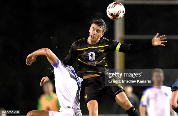 Alex Janovsky of Moreton Bay gets above Jacob Boutoubia of Gold Coast City during the FFA Cup round of 16 match between Moreton Bay United and Gold...