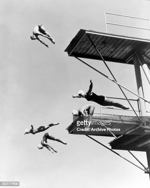 Four female divers and one male practice their form at the high dive at the Arizona Olympic Club, near Phoenix, Arizona, circa 1950.