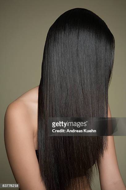 woman with long, shiny hair covering face. - long foto e immagini stock