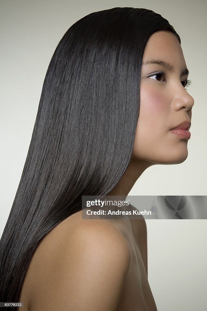 Woman with long shiny hair, profile.