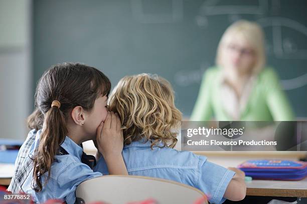 school girl whispering - naughty kids in classroom stock pictures, royalty-free photos & images