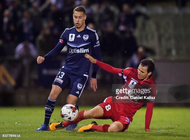 Isaas Sanchez of United tackles Jai Ingham of the Victory during the round of 16 FFA Cup match between Adelaide United and Melbourne Victory at...