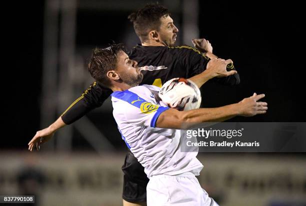 Sam Smith of Gold Coast City and Alex Janovsky of Moreton Bay challenge for the ball during the FFA Cup round of 16 match between Moreton Bay United...