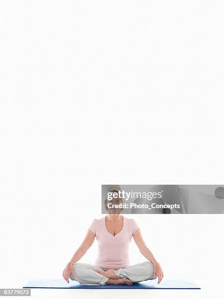 mature woman doing yoga - senior adult white background stock pictures, royalty-free photos & images