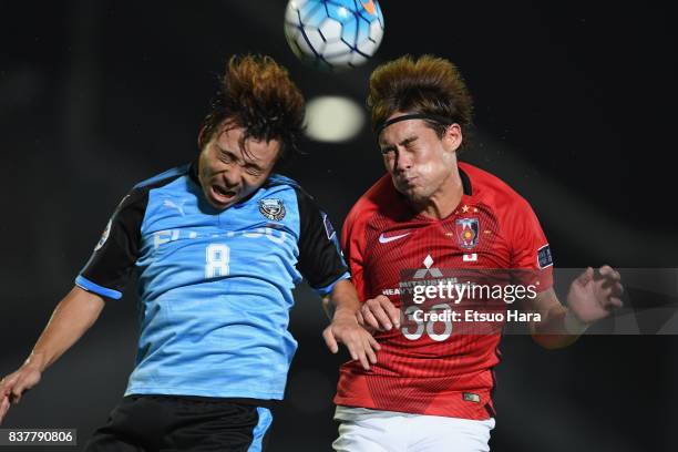 Hiroyuki Abe of Kawasaki Frontale and Daisuke Kikuchi of Urawa Red Diamonds compete for the ball during the AFC Champions League quarter final first...