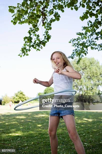 girl with hula-hoop - plastic hoop stock pictures, royalty-free photos & images