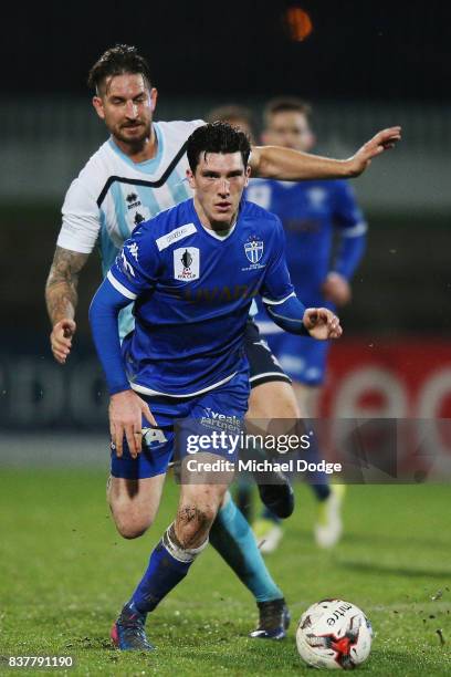 Matthew Millar of South Melbourne runs with the ball ahed of Steven McDonald of Sorrento during the FFA Cup round of 16 match between between South...