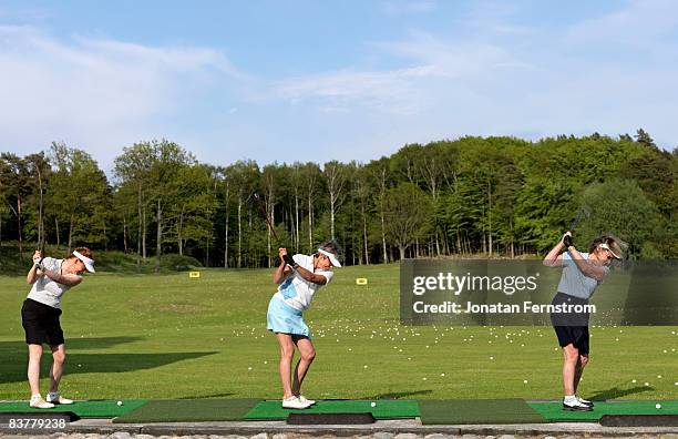 three ladies at driving range - driving range stock pictures, royalty-free photos & images