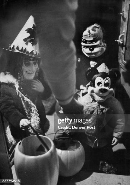 Halloween Characters On Their Rounds Halloween always brings together strange groupings of characters who go about trick-or-treating. At the home of...