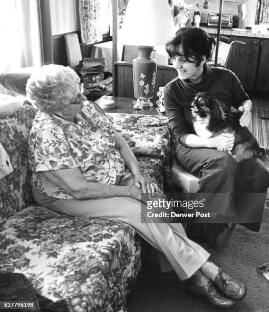 Mrs Eva Crosse 80 yrs Old & Yvonne Kent 45 yrs Old & Mrs Crosse pet dog take a rest after doing a litttle moving in. Credit: Denver Post