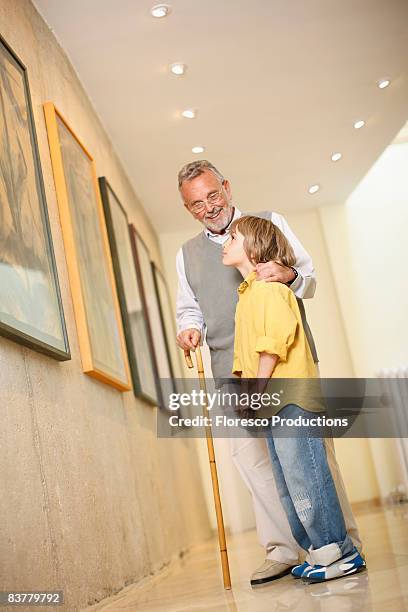 grandfather with grandson in art gallery - pensioners demonstrate in barcelona stock pictures, royalty-free photos & images