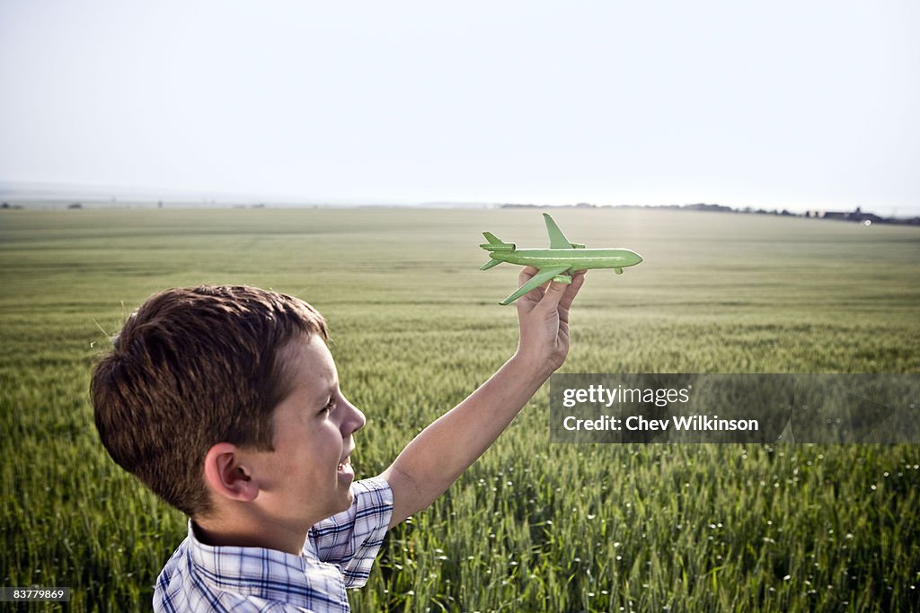 Boy playing with toy plane