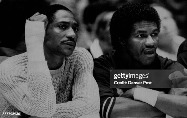 Special Transmission For The Denver Post--Denver's Alex English sits pensively on the Nuggets' bench alongside T.R. Dunn during first - half action...