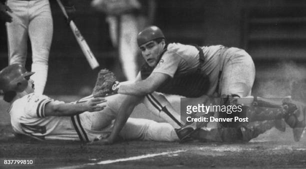 Out at Home -- Louisville catcher Tom Nieto applies the tag to Denver's Dave Hobbs in first-inning action in Friday's third game of the American...