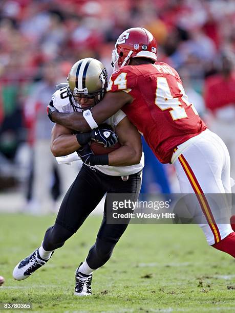 Lance Moore of the New Orleans Saints is tackled by Jarrad Page of the Kansas City Chiefs at Arrowhead Stadium on November 16, 2008 in Kansas City,...