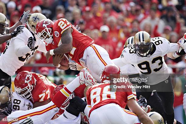 Larry Johnson of the Kansas City Chiefs tries to leap into the end zone over the defense against the New Orleans Saints at Arrowhead Stadium on...