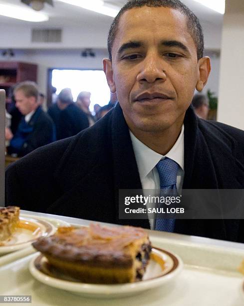 President-elect Barack Obama looks at a piece of pie during a surprise lunch time visit at Manny's Coffee Shop and Deli in Chicago on November 21,...