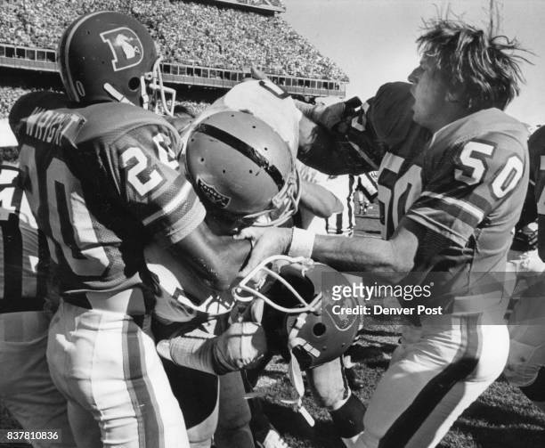 Football - Denver Broncos Louie Wright & Maples struggle it out with Mickey Marvin of Raiders after Marvin grabbed face mask of Bernard Jackson 3rd...