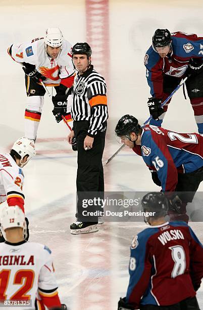 Referee Chris Rooney prepares for face off between the Calgary Flames and the Colorado Avalanche during NHL action at the Pepsi Center on November...