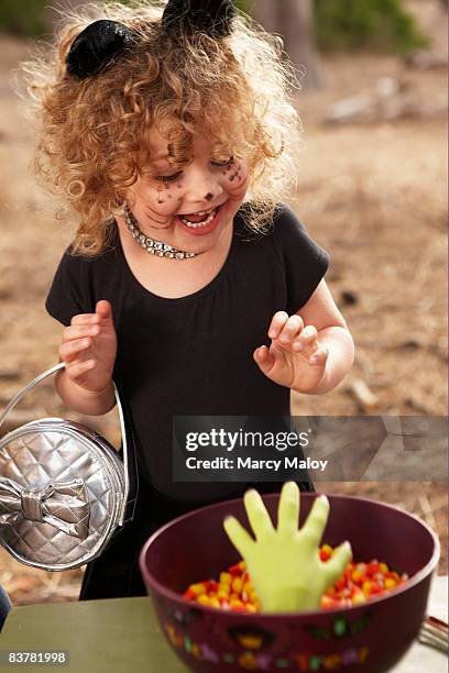 little girl in cat costume with candy bowl. - tierkostüm stock-fotos und bilder