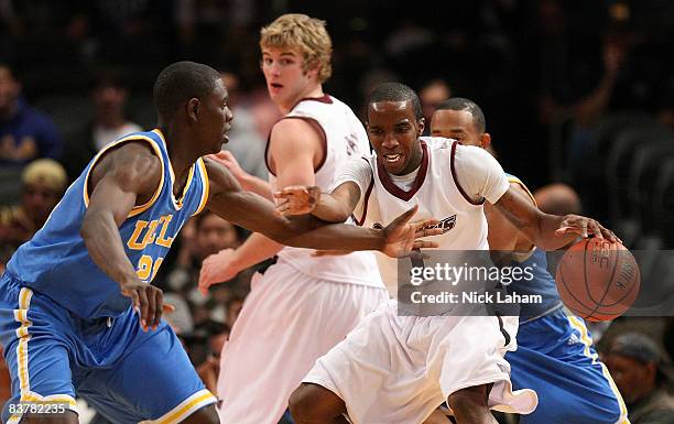 Kevin Dillard of the Southern Illinois Salukis dribbles against Jrue Holiday of the UCLA Bruins on November 21, 2008 at Madison Square Garden in New...