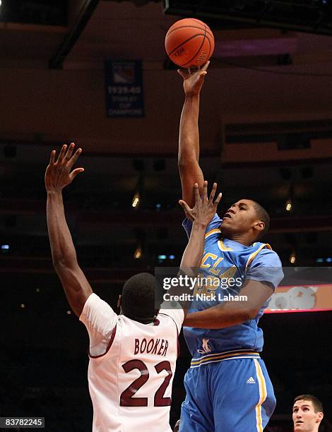 Mison Morgan of the UCLA Bruins shoots over Anthony Booker of the Southern Illinois Salukis on November 21, 2008 at Madison Square Garden in New York...