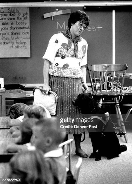 Partially Blind teacher Marge West with her seeing eye dog Rush waits to leave her first grade classroom for lunch on first day of school. Credit:...