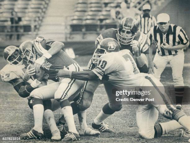 Denver Broncos Tom Jackson and Paul Smith get in a little "Sack Time" as they wrestle charger quarterback Dan Fouts to the turf. Credit: Denver Post