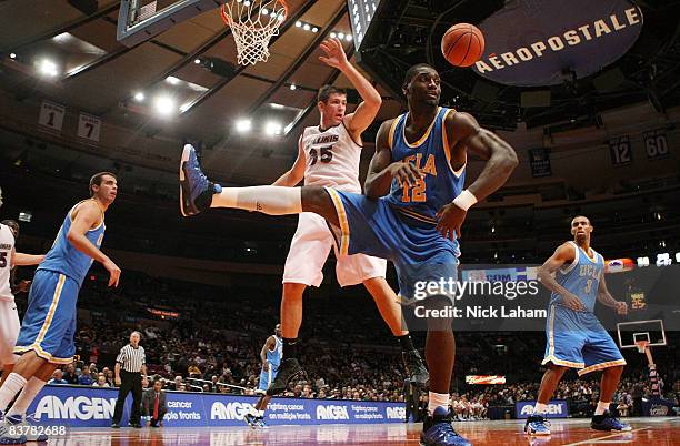 Alfred Aboya of the UCLA Bruins contests a rebound with Tony Boyle of the Southern Illinois Salukis on November 21, 2008 at Madison Square Garden in...