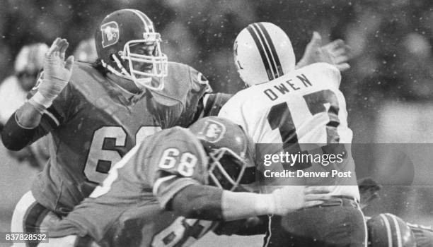 Football - Denver Broncos John Grant & Rubin Caster Sack Tom Dwen in the second period Credit: Denver Post