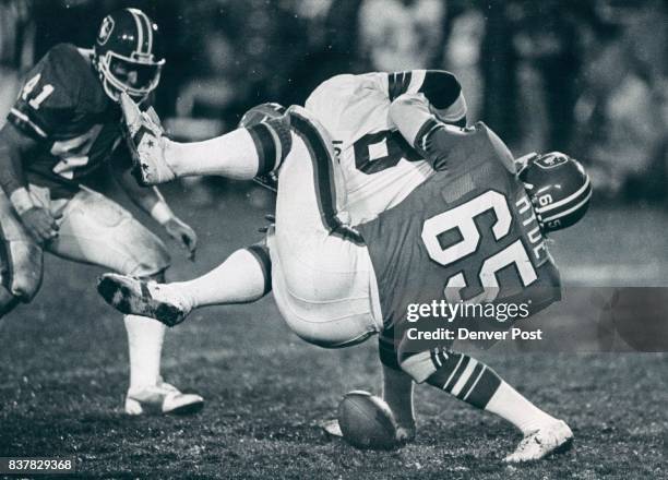 Hyde, Glenn - Groups Football Bronco's Glenn Hyde wraps up Seattle punter Jeff West after West mishandled the snap from center. Rob Lytle closes in...