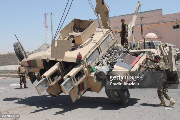 Crane truck picks up wrecked armored vehicles after a suicide attack which had conducted with a bomb-laden vehicle to a military convoy in...