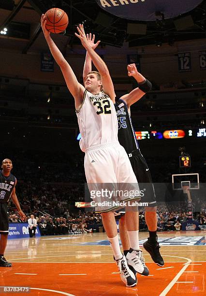 Zack Gibson of the Michigan Wolverines lays the ball up against the Duke Blue Devils on November 21, 2008 at Madison Square Garden in New York City.