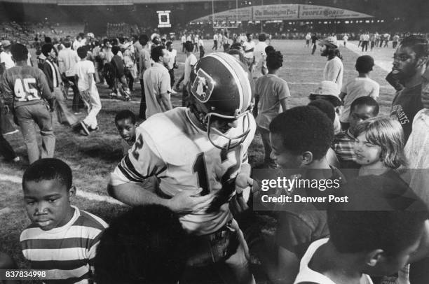 Denver Broncos Exhibition Games Charley Johnson gives wrist bands Charley Johnson Gets Touched for Slight Loss After Game Young Washington fan puts...