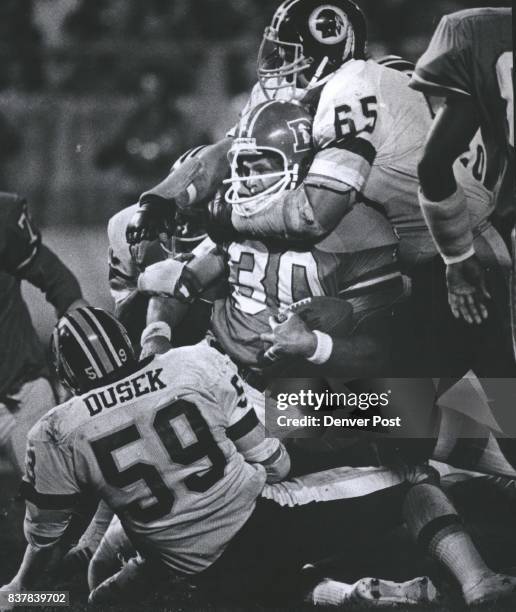 Dave Butz keeps a choke hold on Jim Jensen - Holding Jensen to a one yard gain late in the Fourth Qtr. Credit: Denver Post