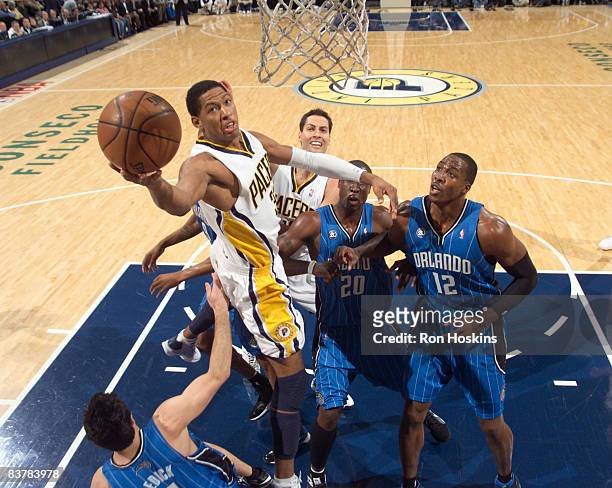 Danny Granger of the Indiana Pacers shoots around Dwight Howard and Mickael Pietrus of the Orlando Magic at Conseco Fieldhouse on November 21, 2008...