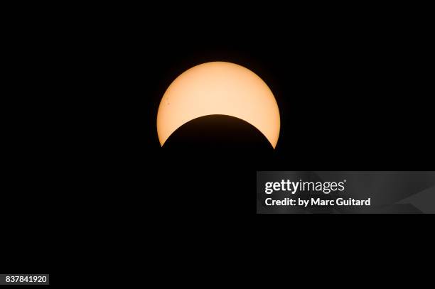 partial solar eclipse seen from fredericton, new brunswick, canada - solar eclipse in canada stock pictures, royalty-free photos & images