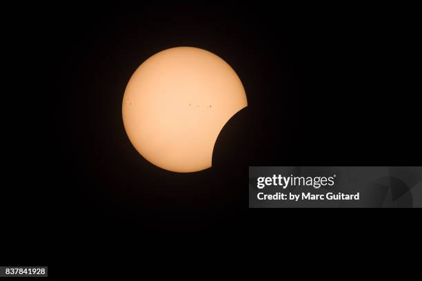 partial solar eclipse seen from fredericton, new brunswick, canada - solar eclipse in canada stock pictures, royalty-free photos & images