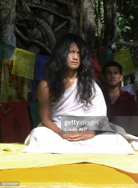 Nepalese youth Ram Bahadur Bomjam sits under a pipal tree before an audience gathered to listen to his sermon in the village of Ratanpuri in Bara...