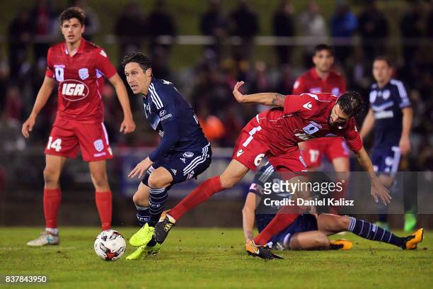 Mark Milligan of the Victory competes for the ball with Vince Lia of United during the round of 16 FFA Cup match between Adelaide United and...