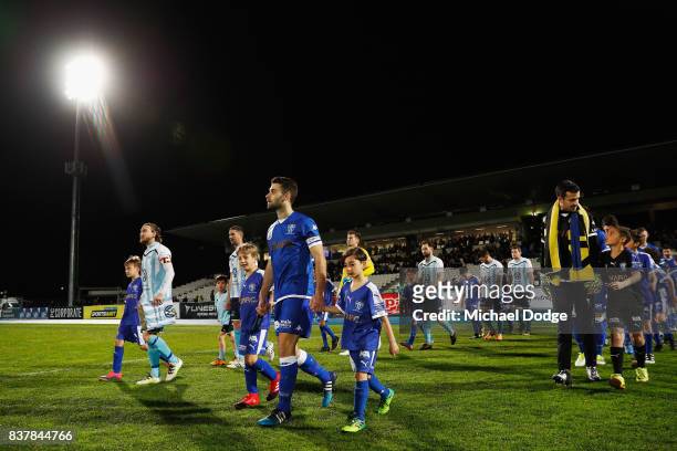 Captains Daryl Platten of Sorrento and Brad Norton of South Melbourne walk out during the FFA Cup round of 16 match between between South Melbourne...