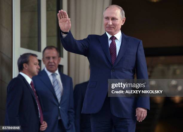 Russian President Vladimir Putin waves goodbye to Israeli Prime Minister after their meeting at the Bocharov Ruchei state residence in Sochi on...