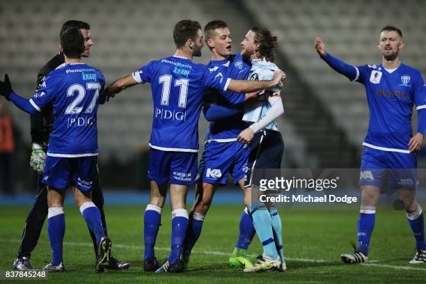 Daryl Platten of Sorrento tries to confront Goalkeeper Nikola Roganovic of South Melbourne during the FFA Cup round of 16 match between between South...