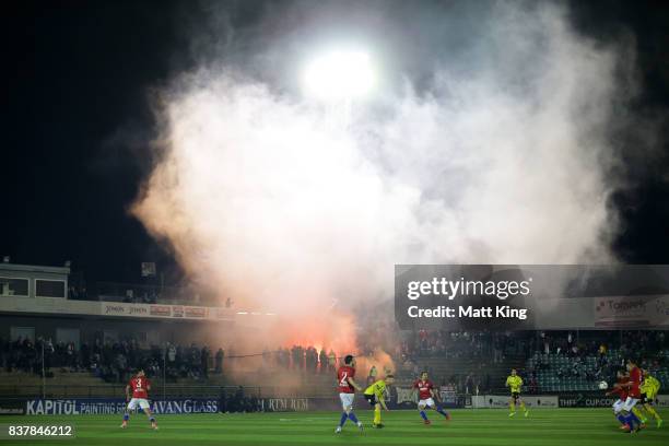 General view as smoke from a flare rises over the pitch during the FFA Cup round of 16 match between Sydney United 58 FC and Heidleberg United at...