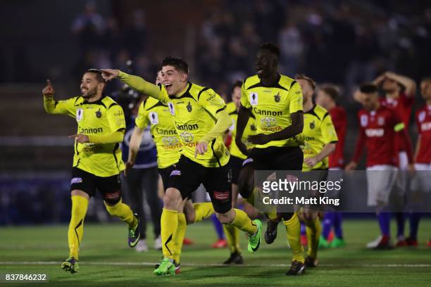 Alexander Schiavo of Heidleberg United and team mates celebrate victory after the penalty shoot out during the FFA Cup round of 16 match between...