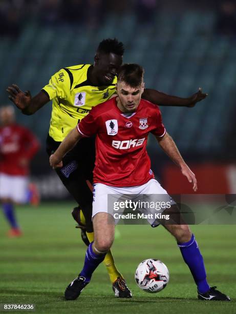 Anthony Tomelic of Sydney United 58 FC is challenged by Ken Athiu of Heidleberg United during the FFA Cup round of 16 match between Sydney United 58...