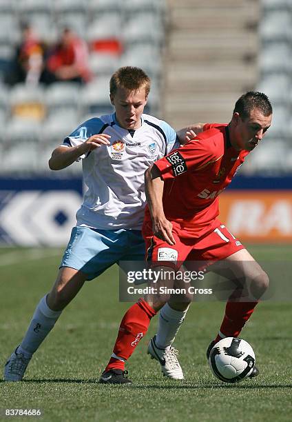 Shane Tobias of United holds off Sam Munro of Sydney during the round nine National Youth League match between Adelaide United and Sydney FC at...