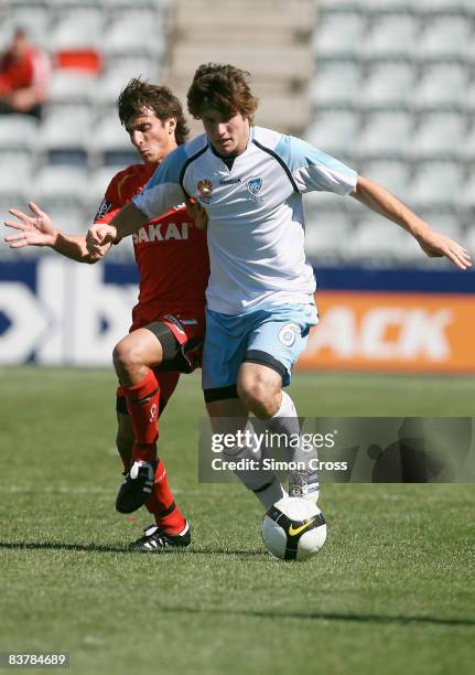 Chris Payne of Sydney holds off Jason Spagnuolo of United during the round nine National Youth League match between Adelaide United and Sydney FC at...